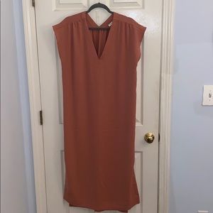 Long salmon colored dress with slit.